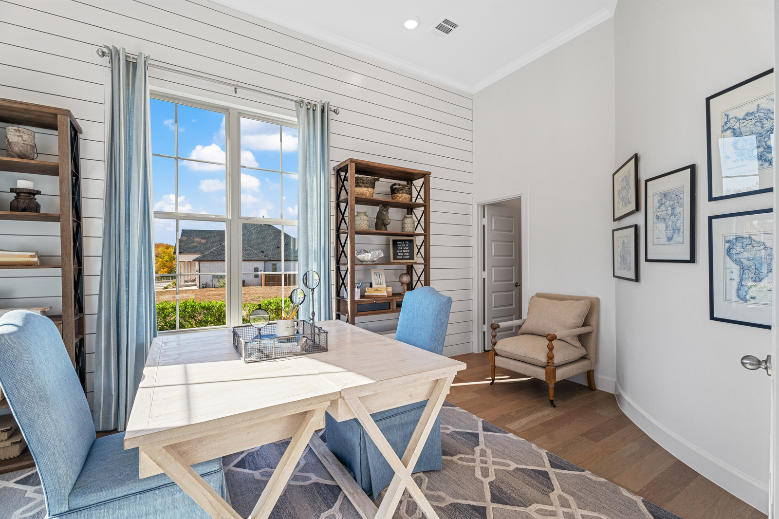 private study with large window and wood floors