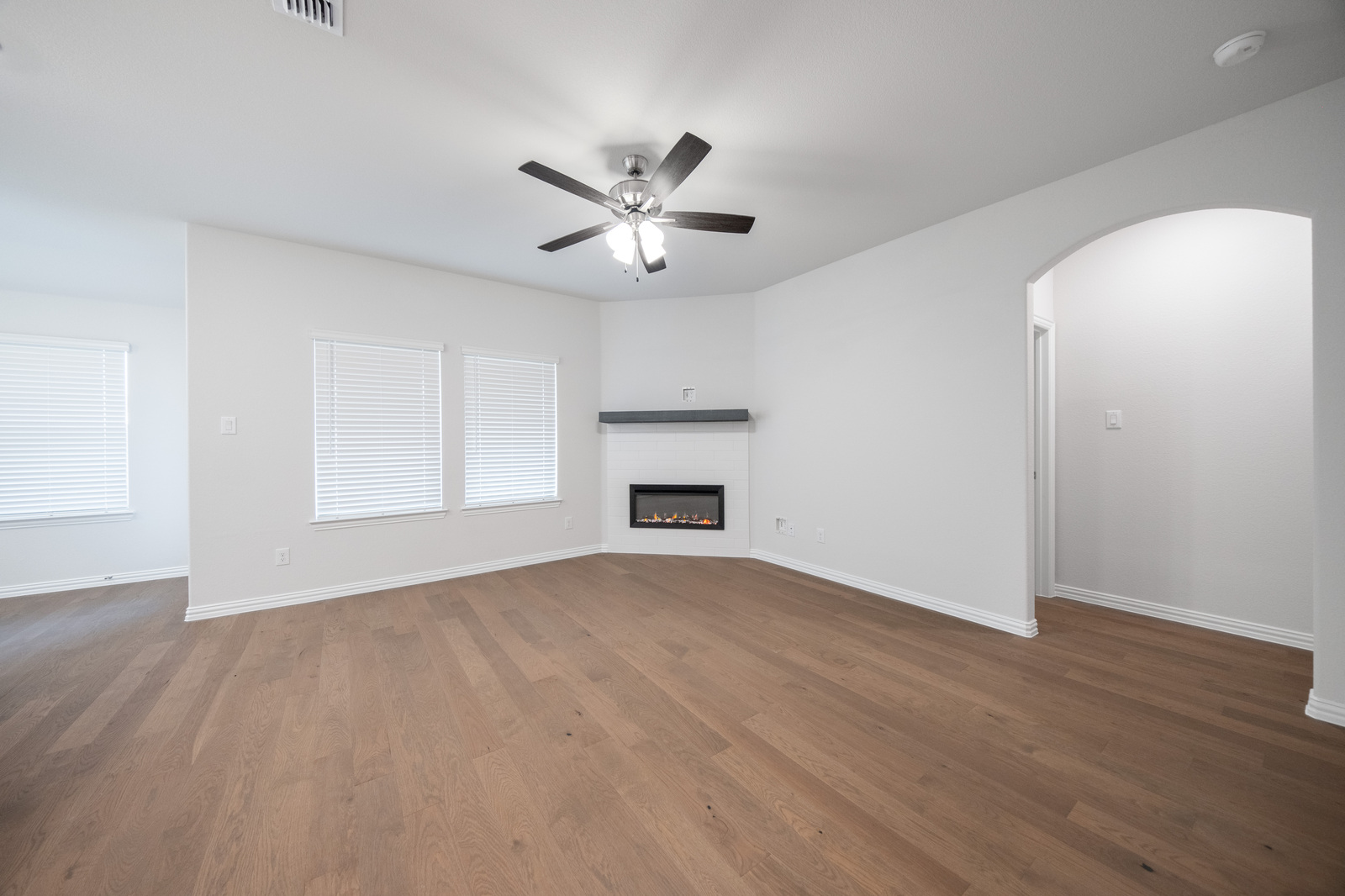 open great room with hardwood flooring and windows