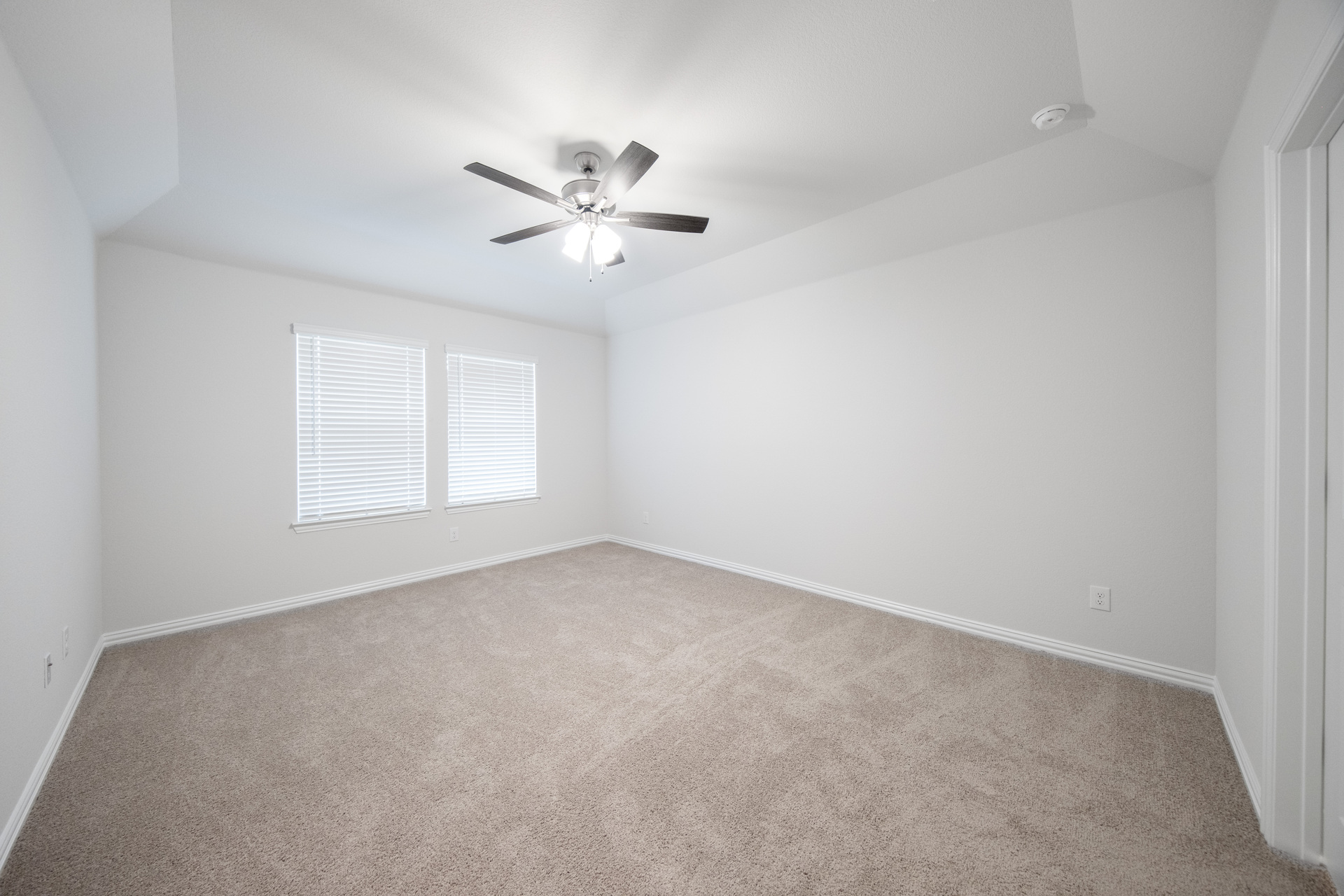 primary bathroom with carpet and windows