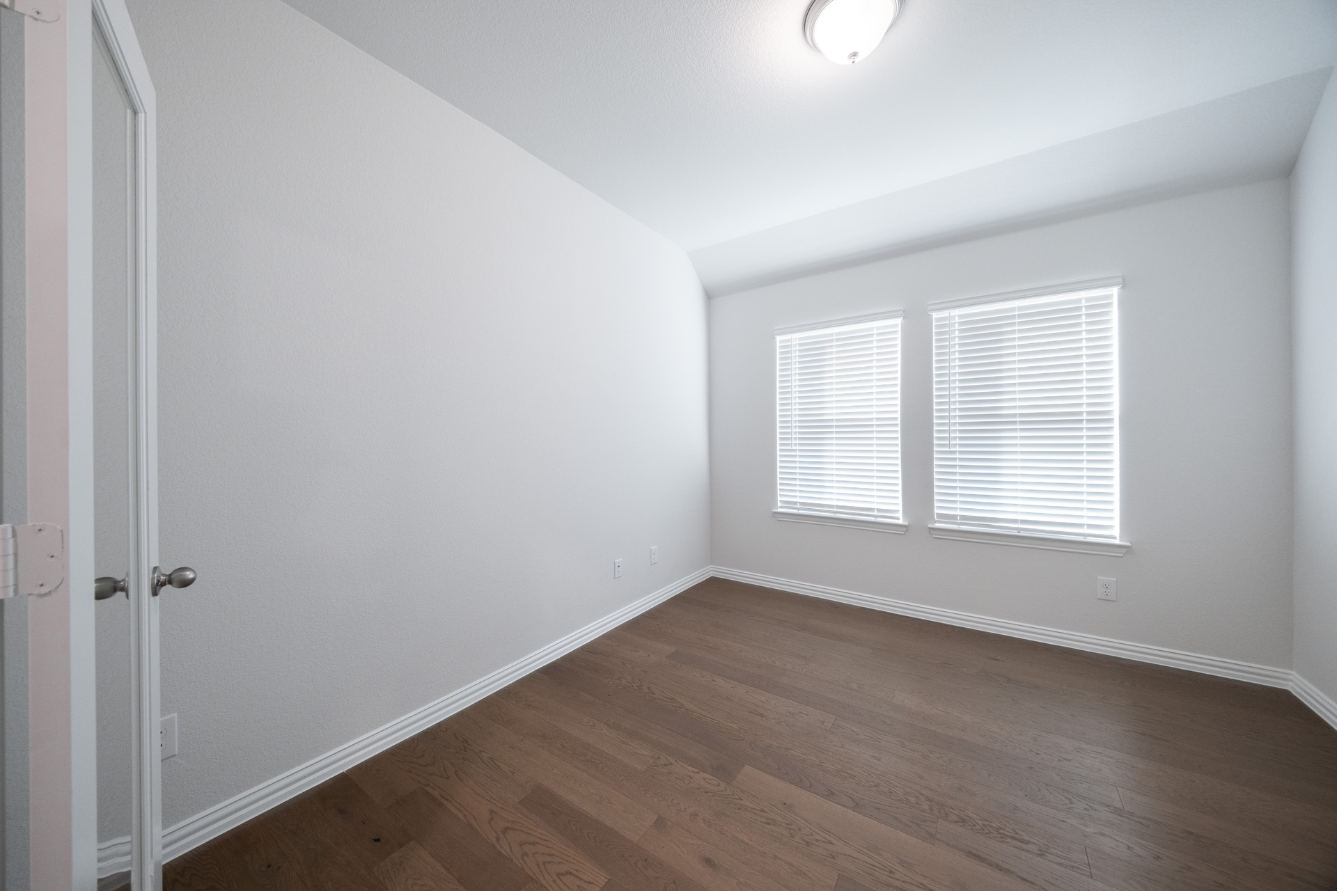 spacious study with hardwood flooring