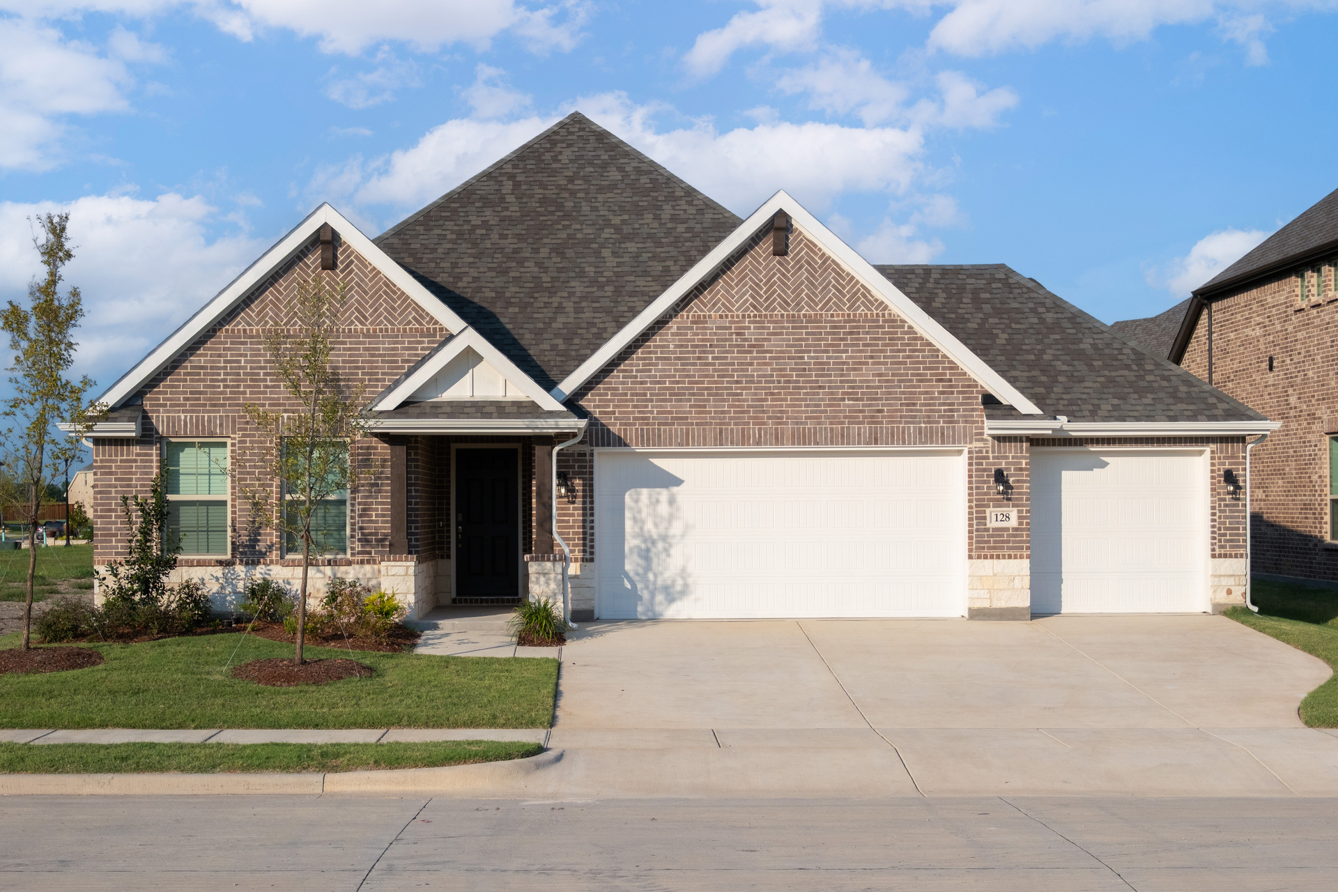 exterior of home with brown brick and white stone