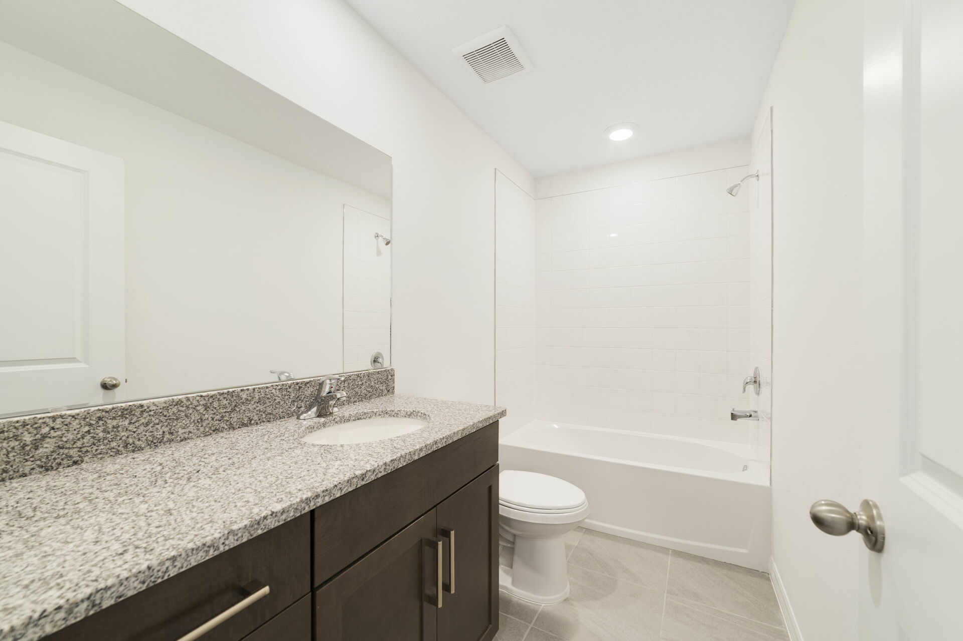 single sink vanity with water closet and large mirror 