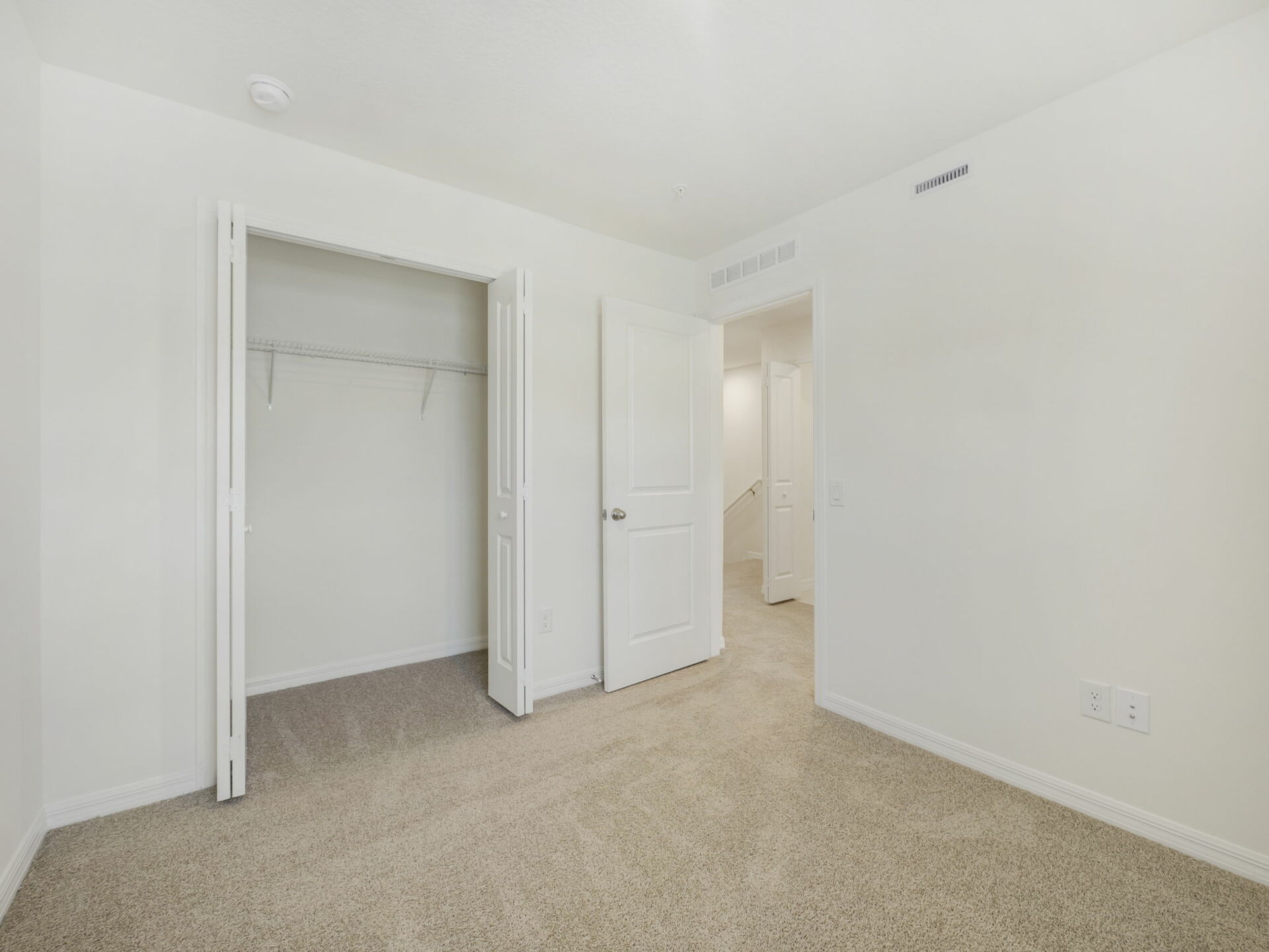 guest bedroom with carpet throughout and large window
