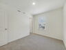 secondary bedroom with carpet and large window