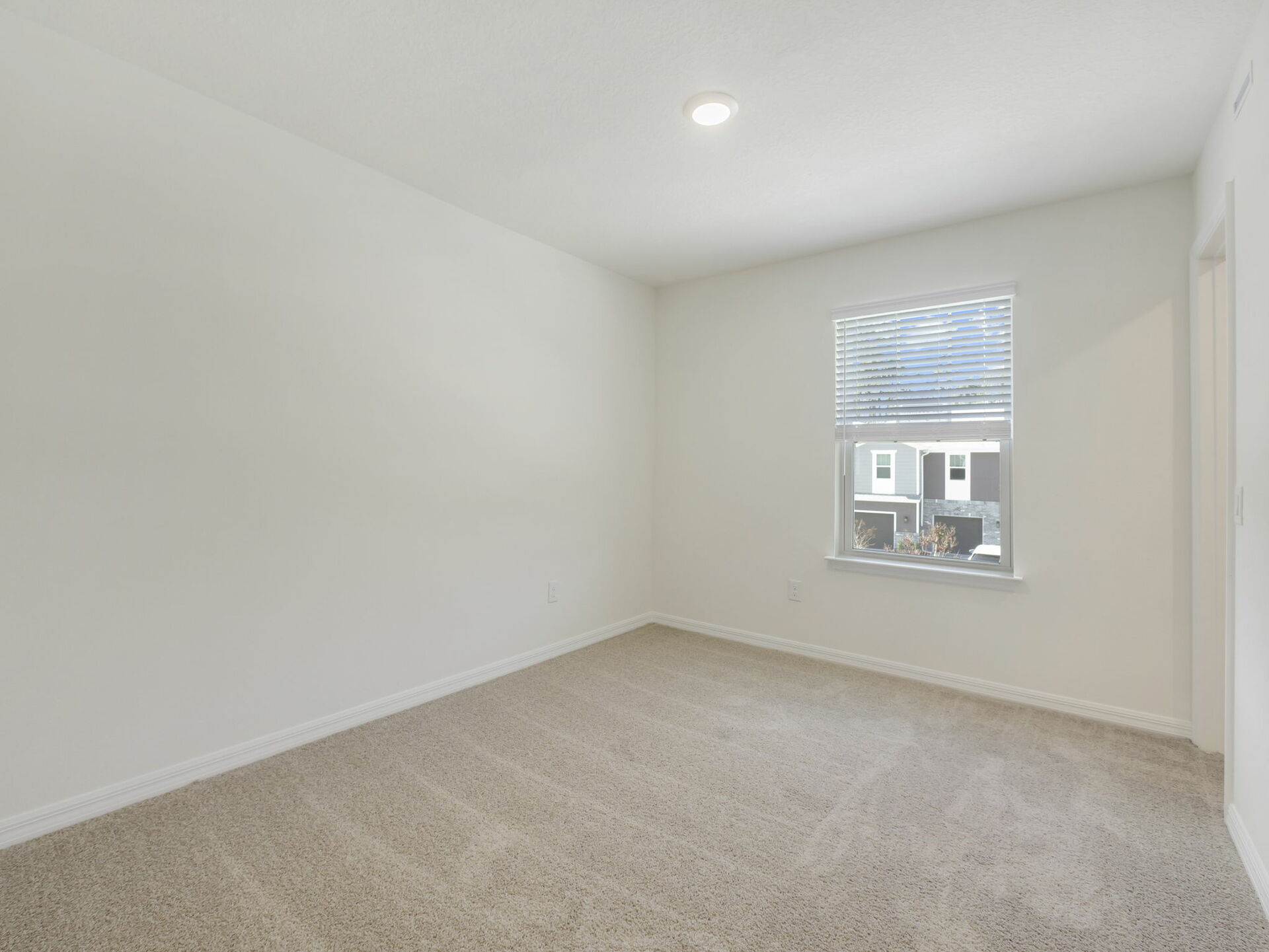 room with carpet throughout and a large window