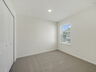 secondary bedroom with carpet and large window