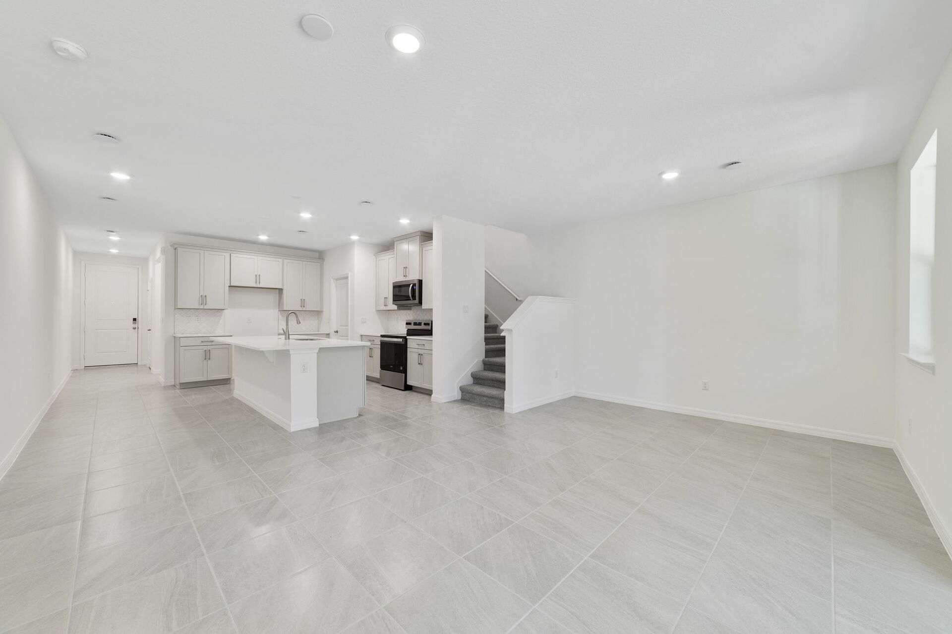 great room with access to lanai and view of the kitchen