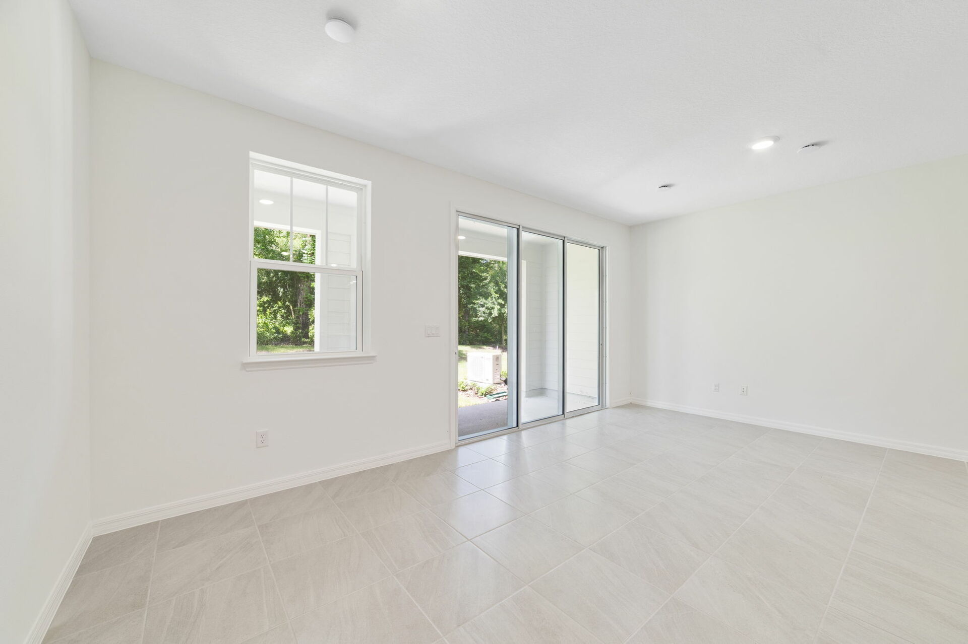 great room with access to lanai and view of the kitchen