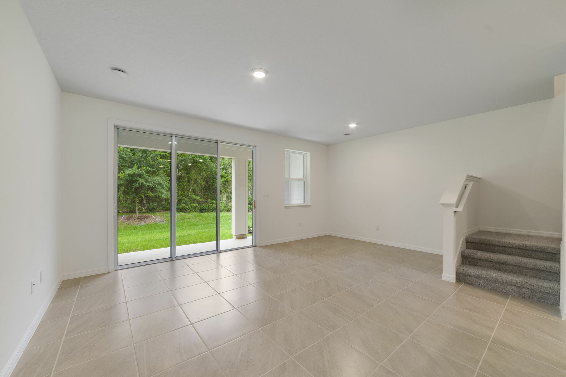 room with view of lanai and access to the kitchen