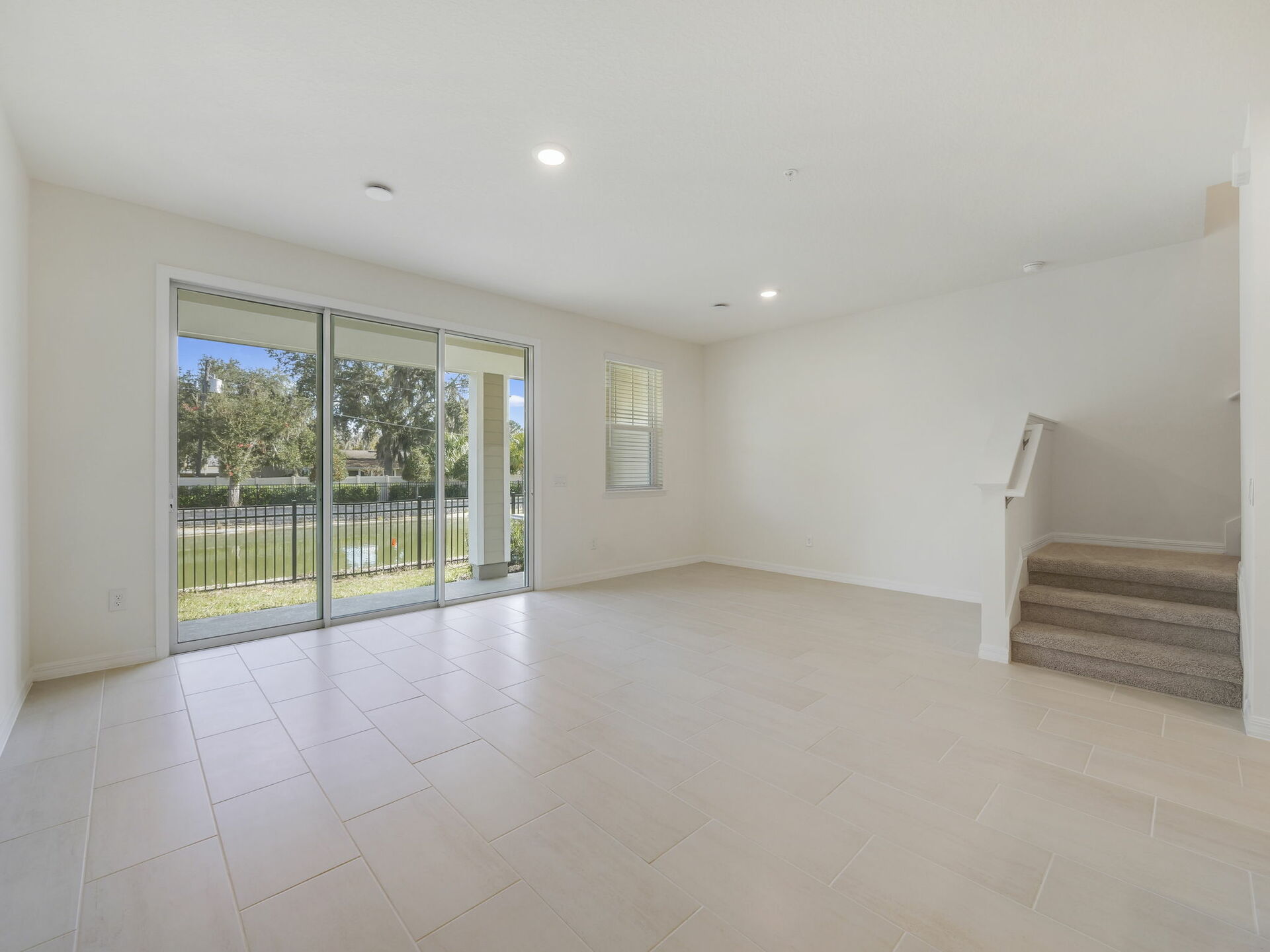 room with view of kitchen and sliding glass door to covered lanai