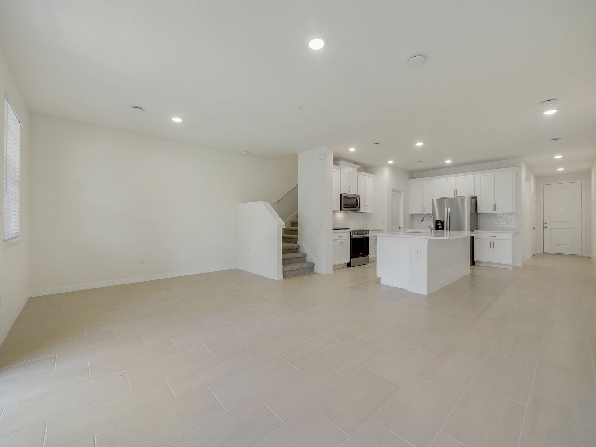 room with view of kitchen and sliding glass door to covered lanai