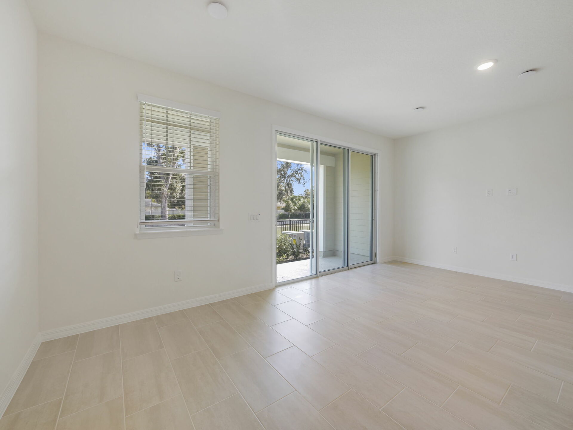 great room with view of kitchen and sliding glass door to the lanai