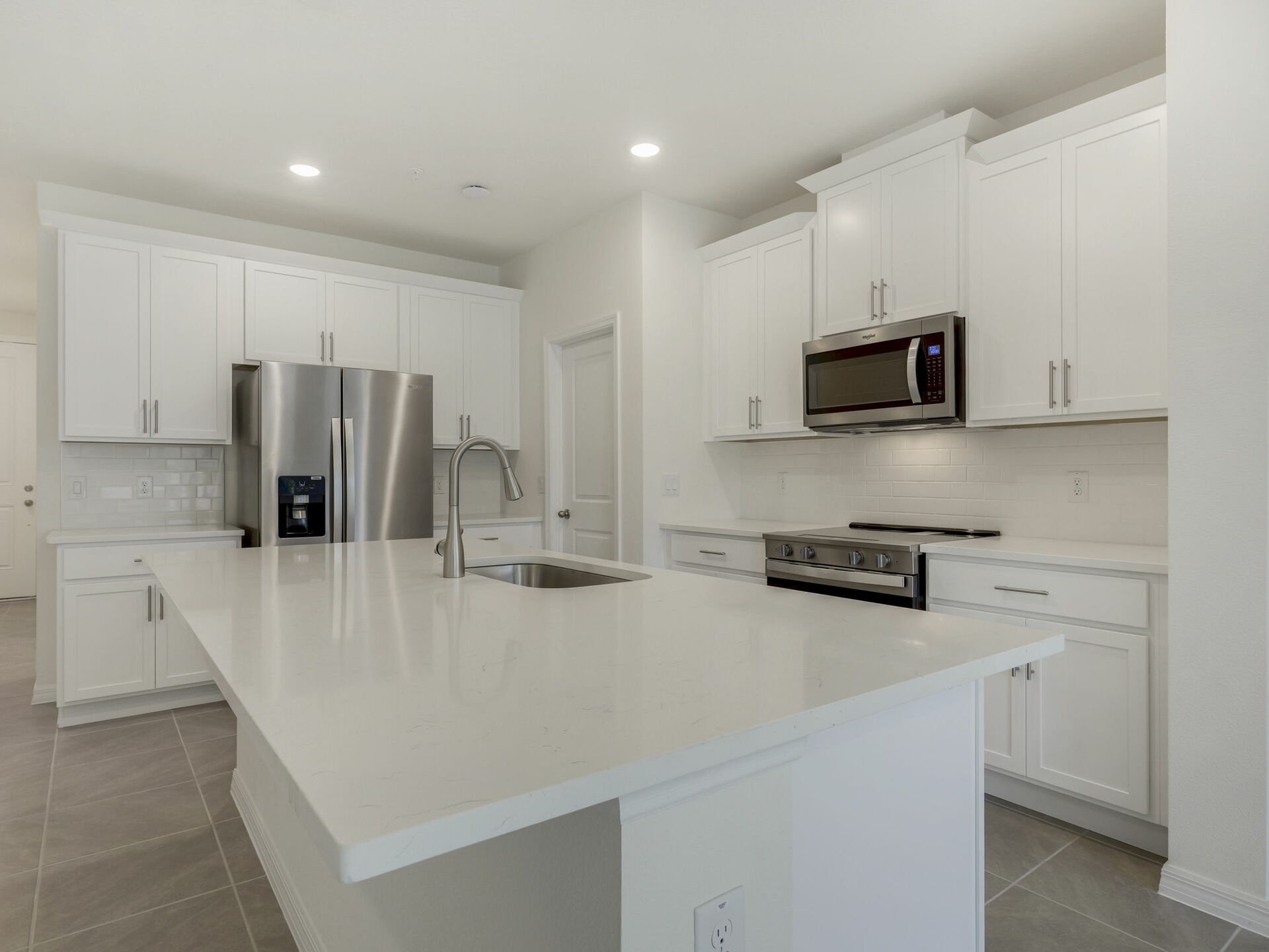 view of center island, stairs and great room