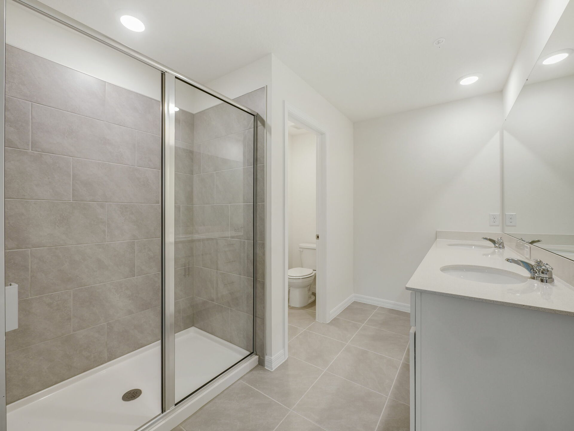 dual sink vanity, shower and water closet