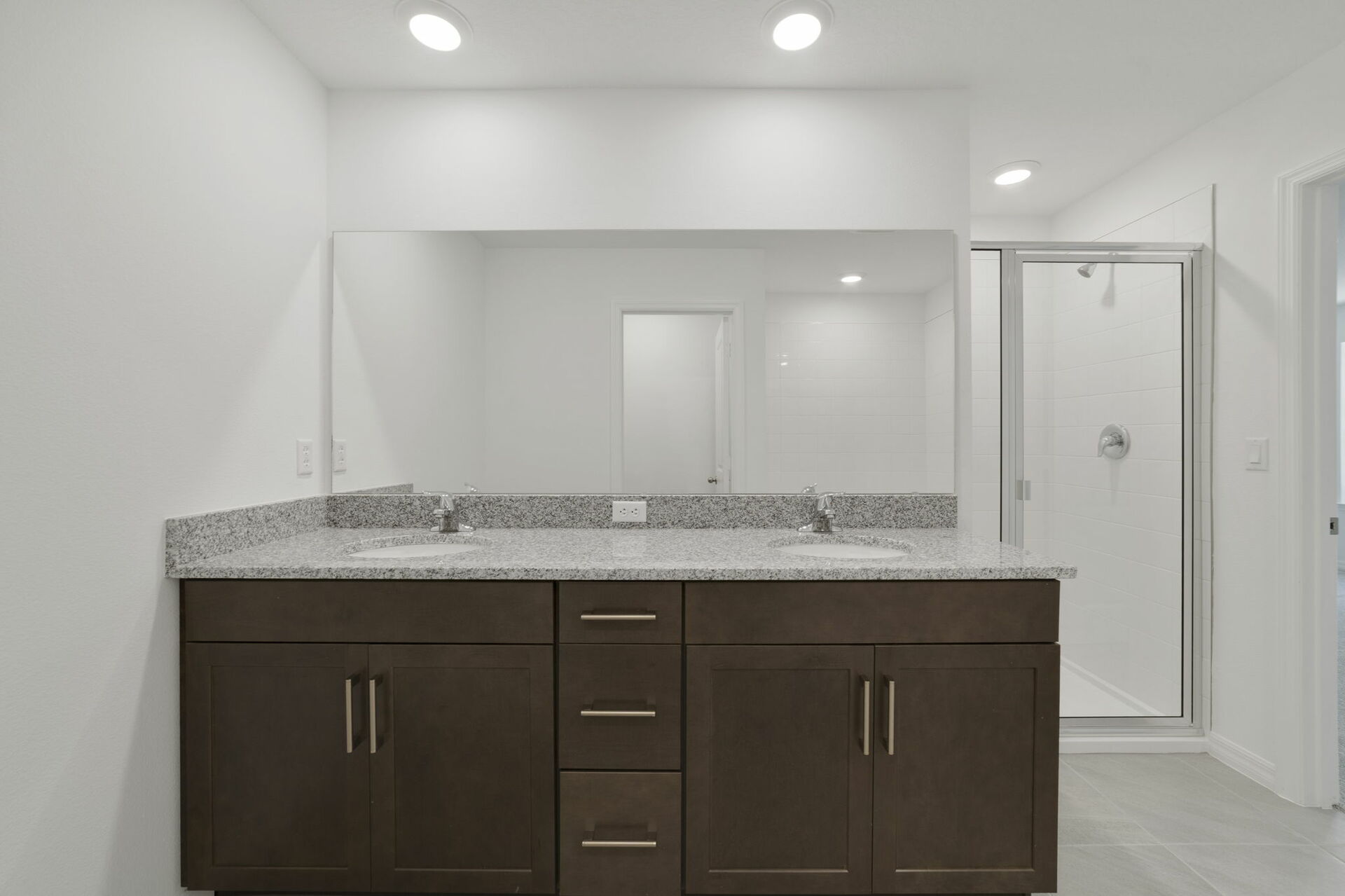 dual sink vanity with water closet, shower, and tub