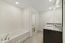 dual sink vanity with water closet, shower, and tub