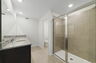 dual sink vanity with water closet and shower