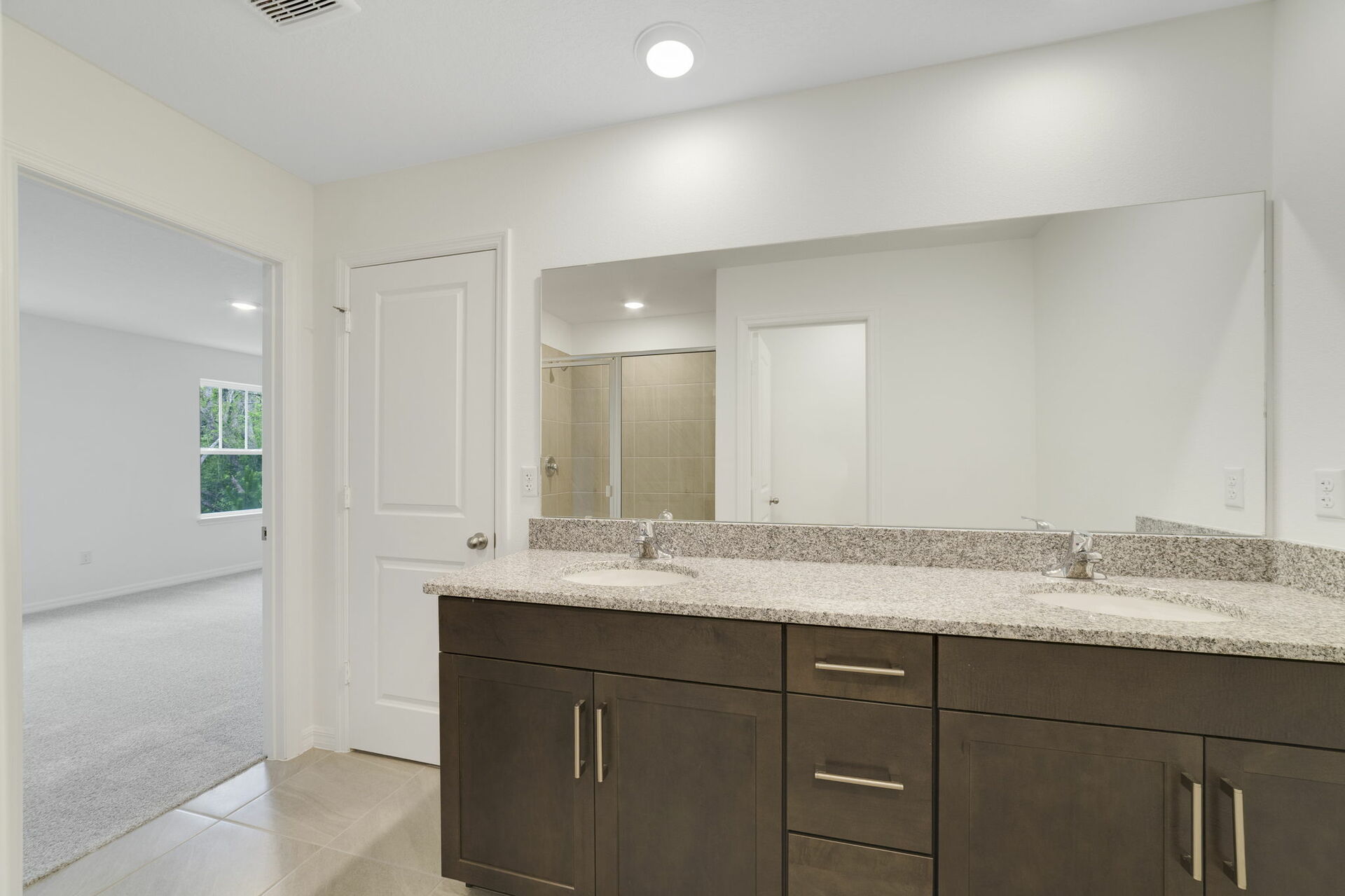 dual sink vanity with water closet and shower
