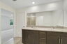 dual sink vanity with water closet and shower