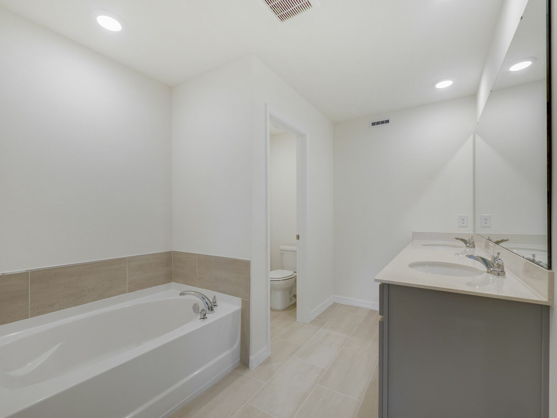 dual sink vanity, shower and tub