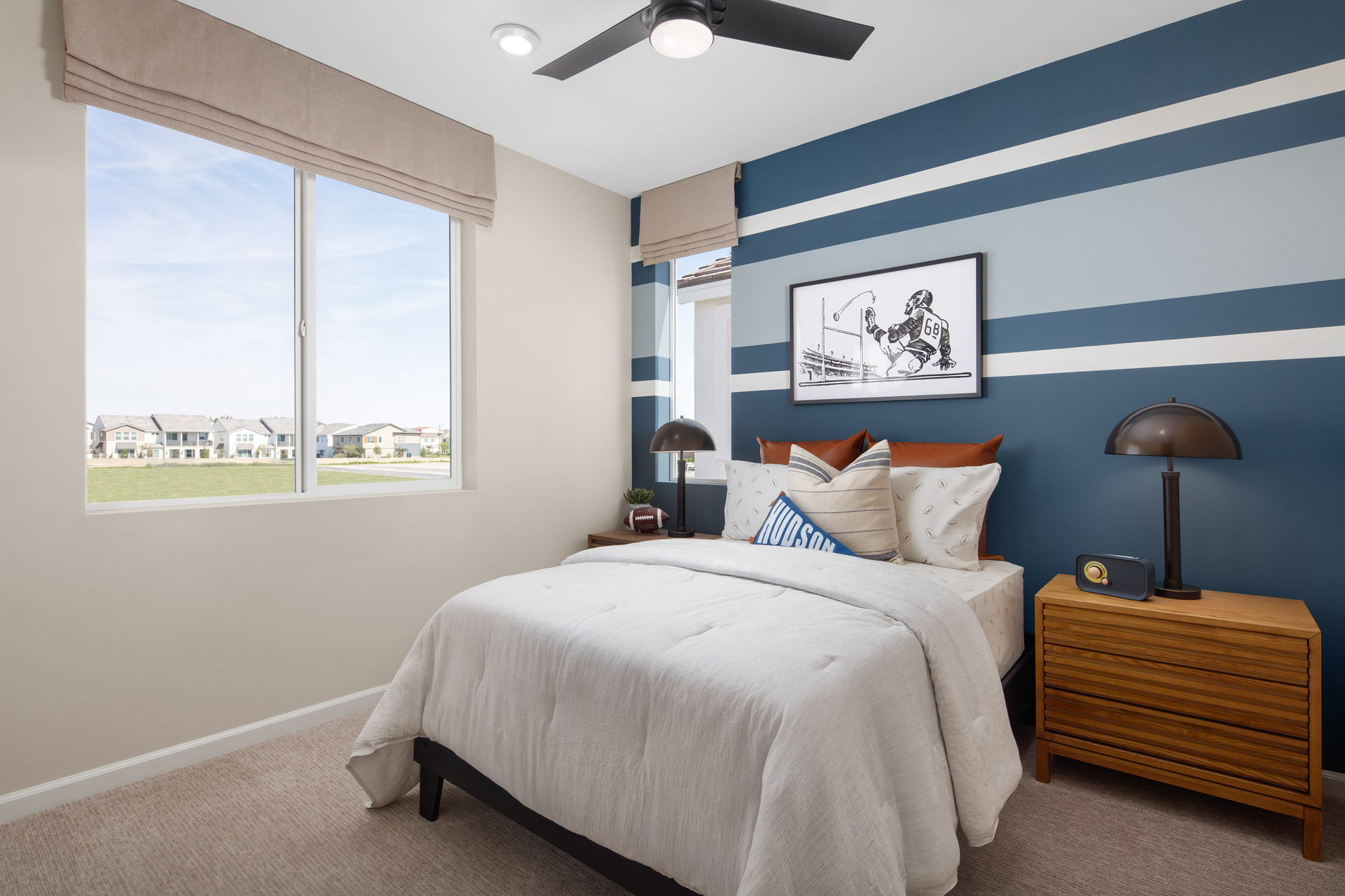 bedroom with accent wall and large window