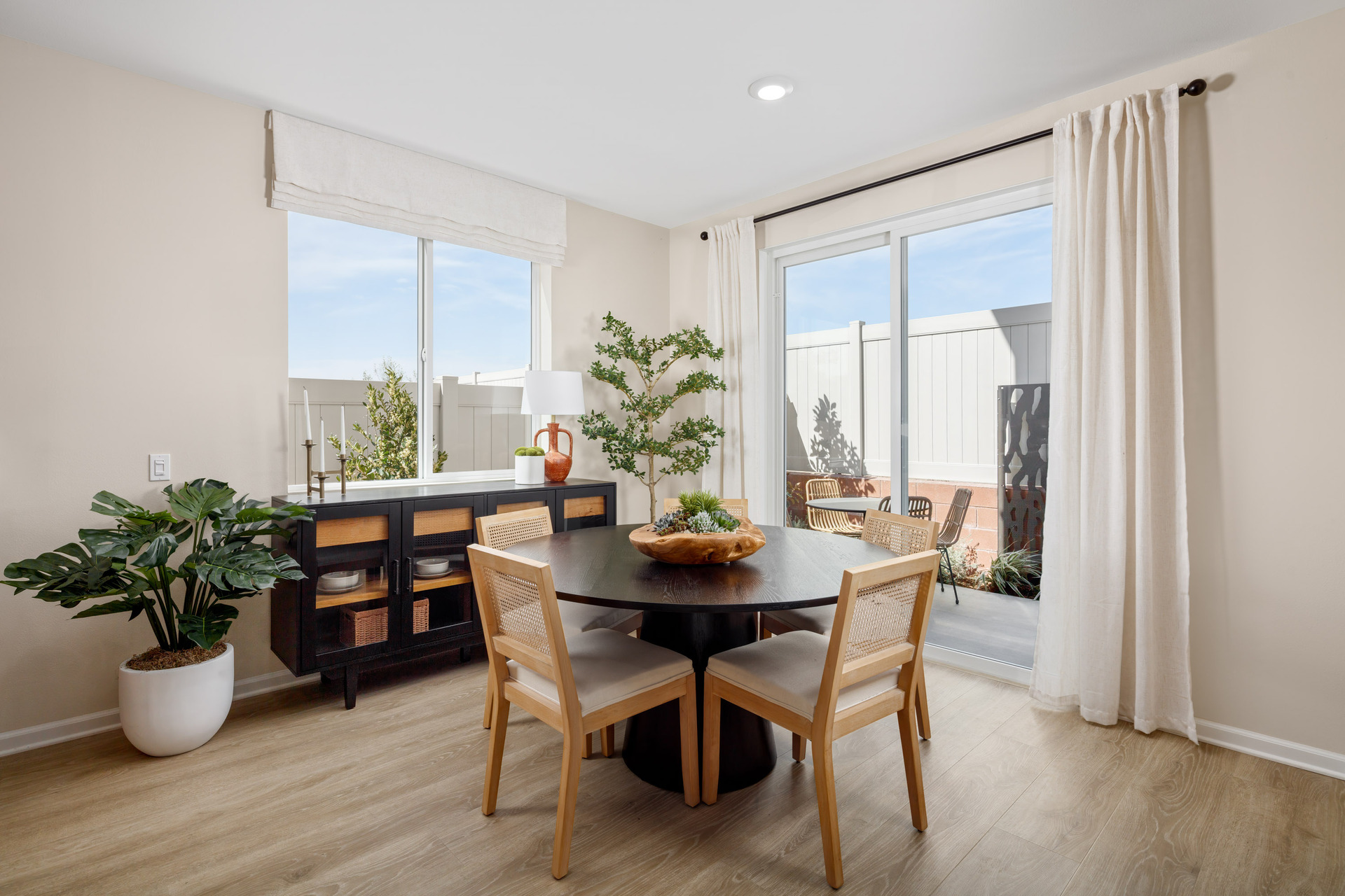dining area with neutral floors and large window