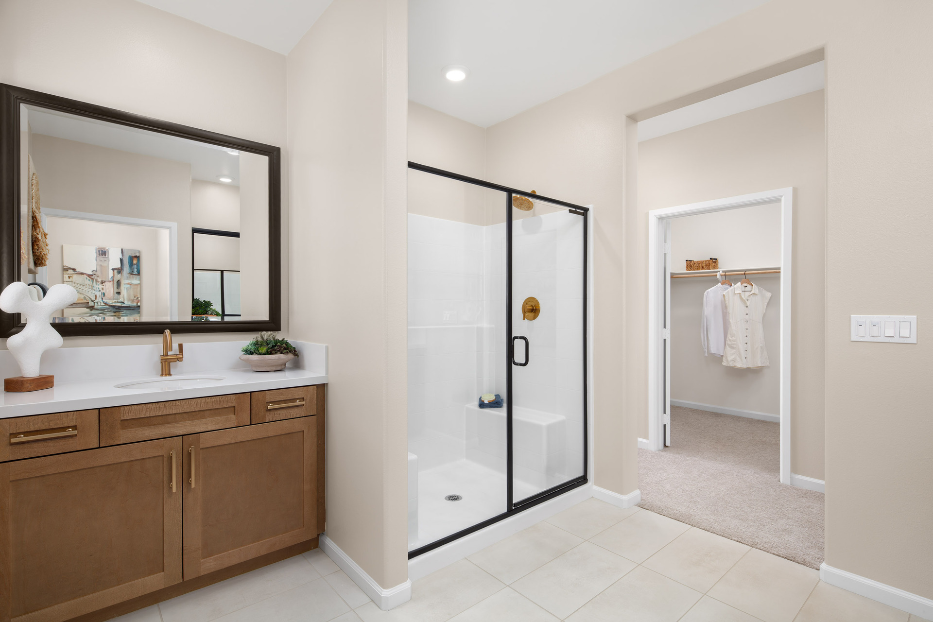 primary bathroom with split sinks and tile floors