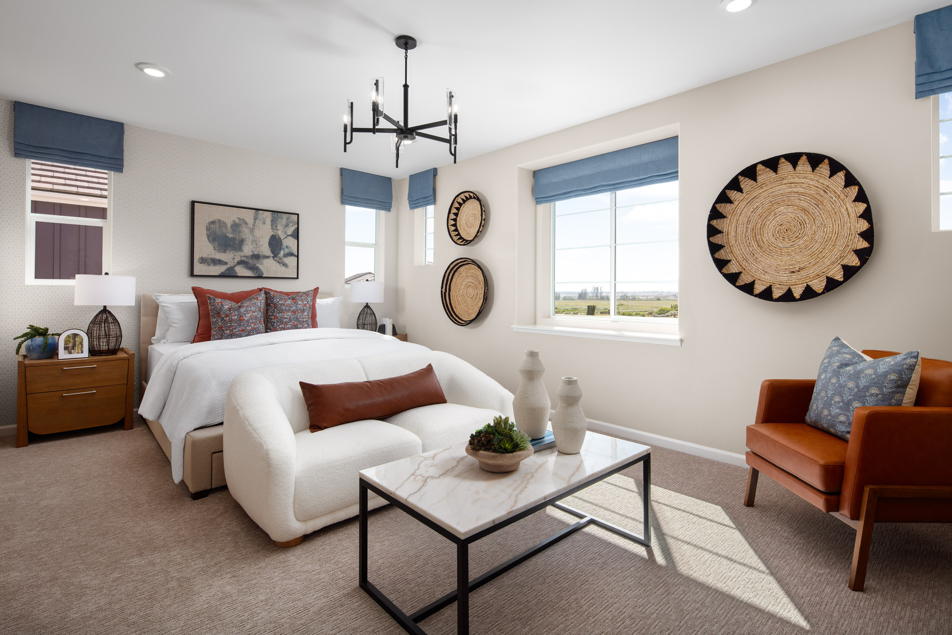 primary bedroom with neutral carpet and large windows