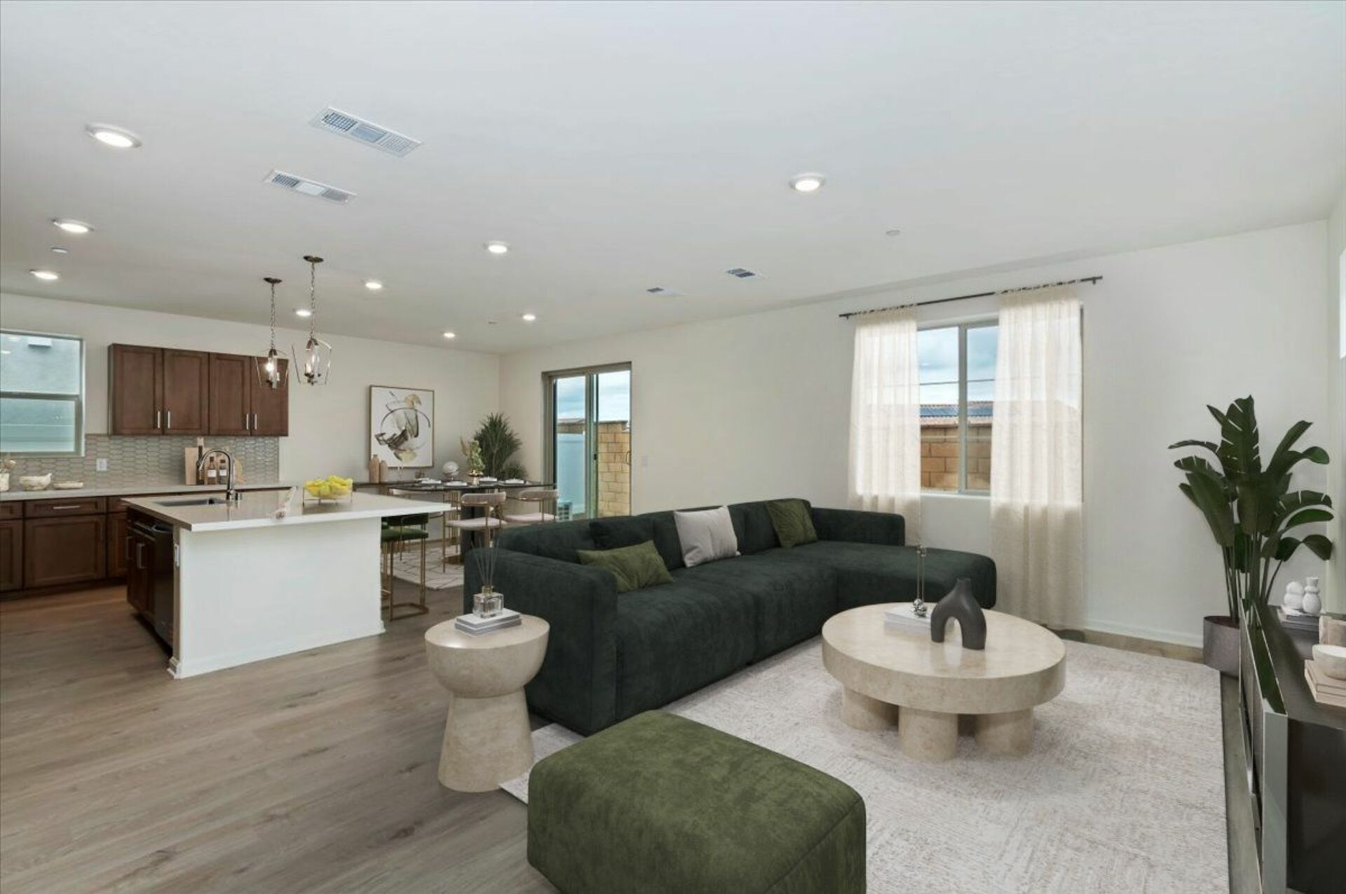 great room with neutral floors neat kitchen and dining area