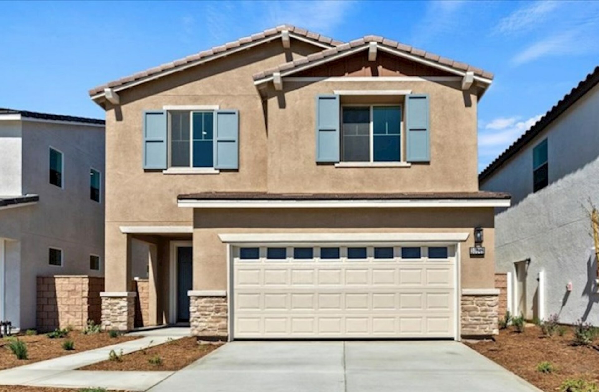 two-story exterior with a white windowed garage