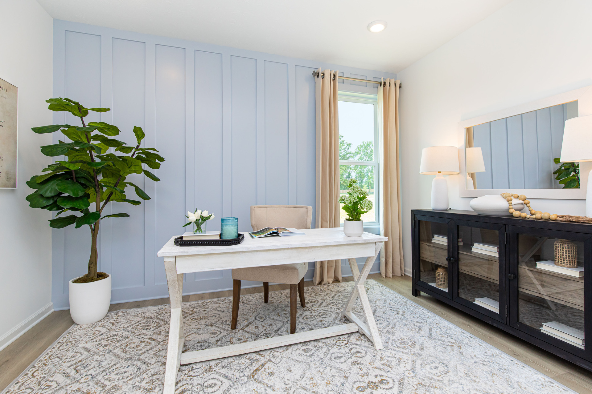 study with blue accent wall and desk