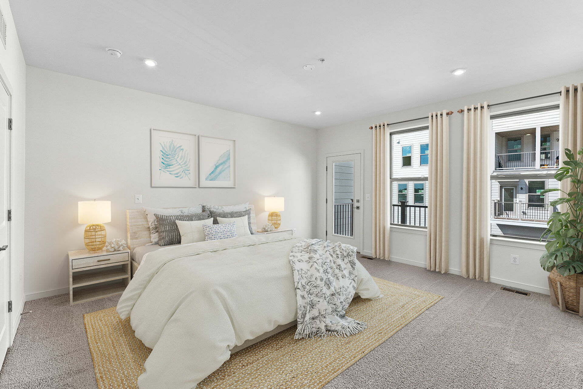 primary bedroom with two windows and bed