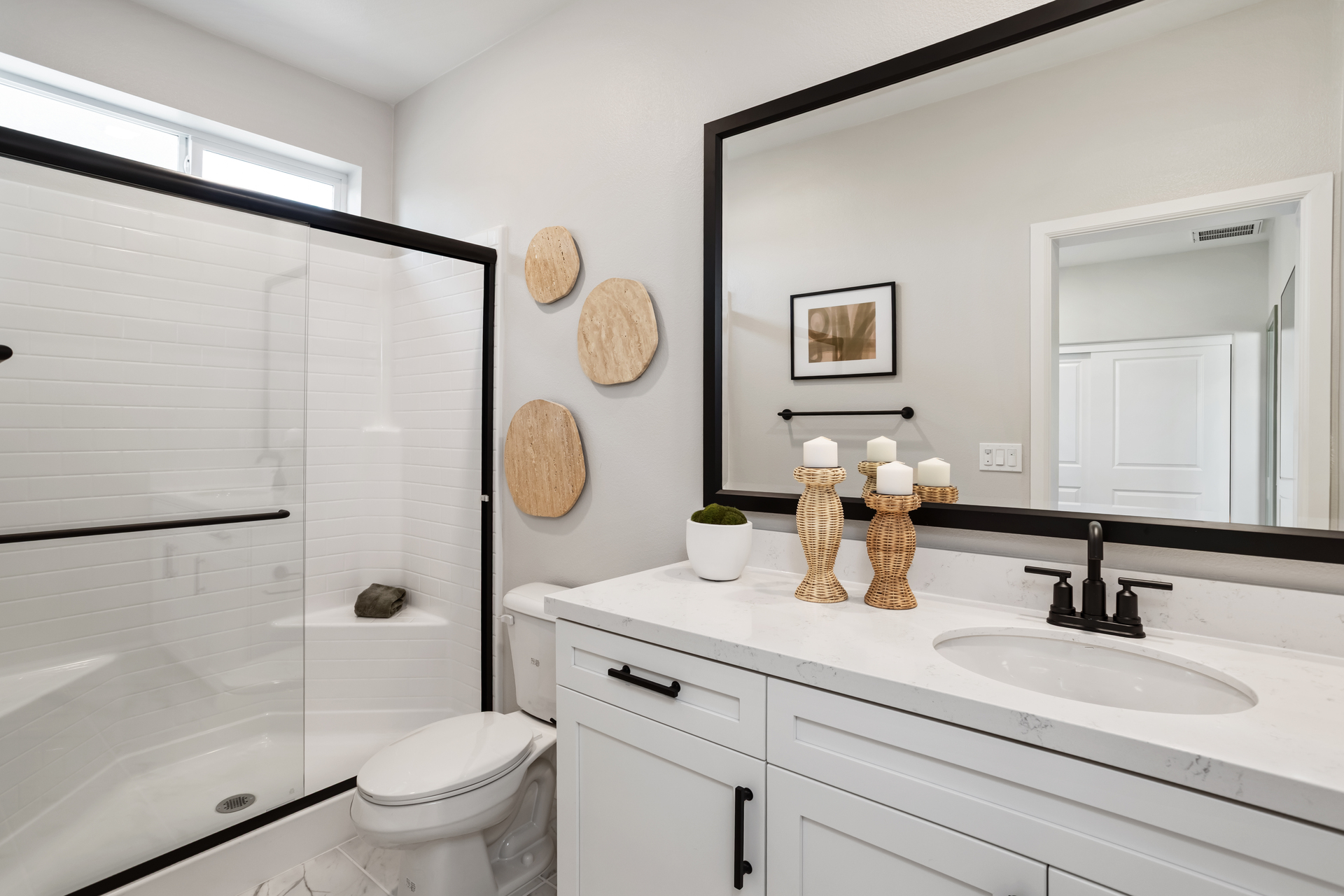 bathroom with white cabinets and countertops