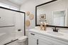 bathroom with white cabinets and countertops