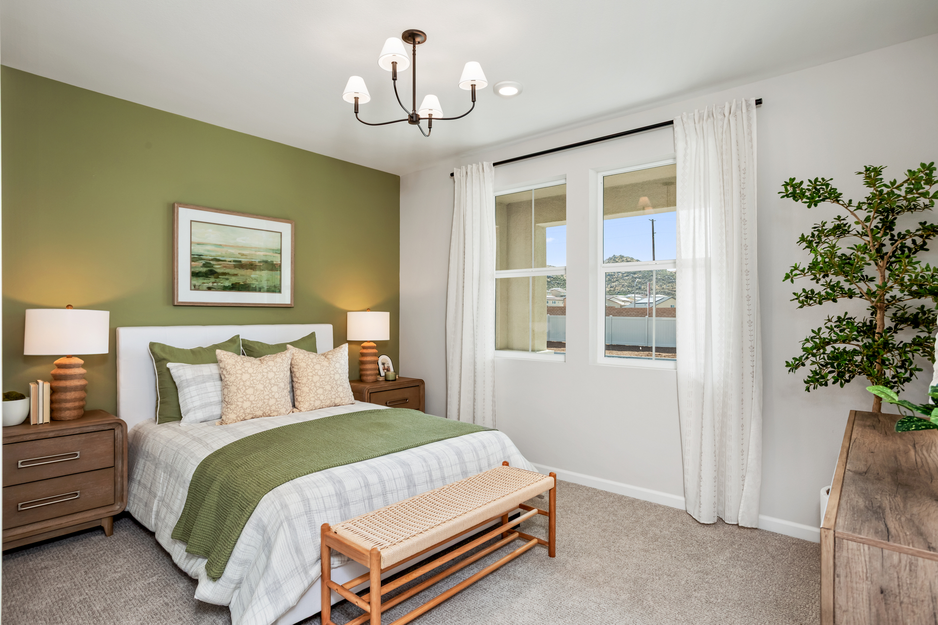 bedroom with accent wall and large windows