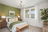 bedroom with accent wall and large windows