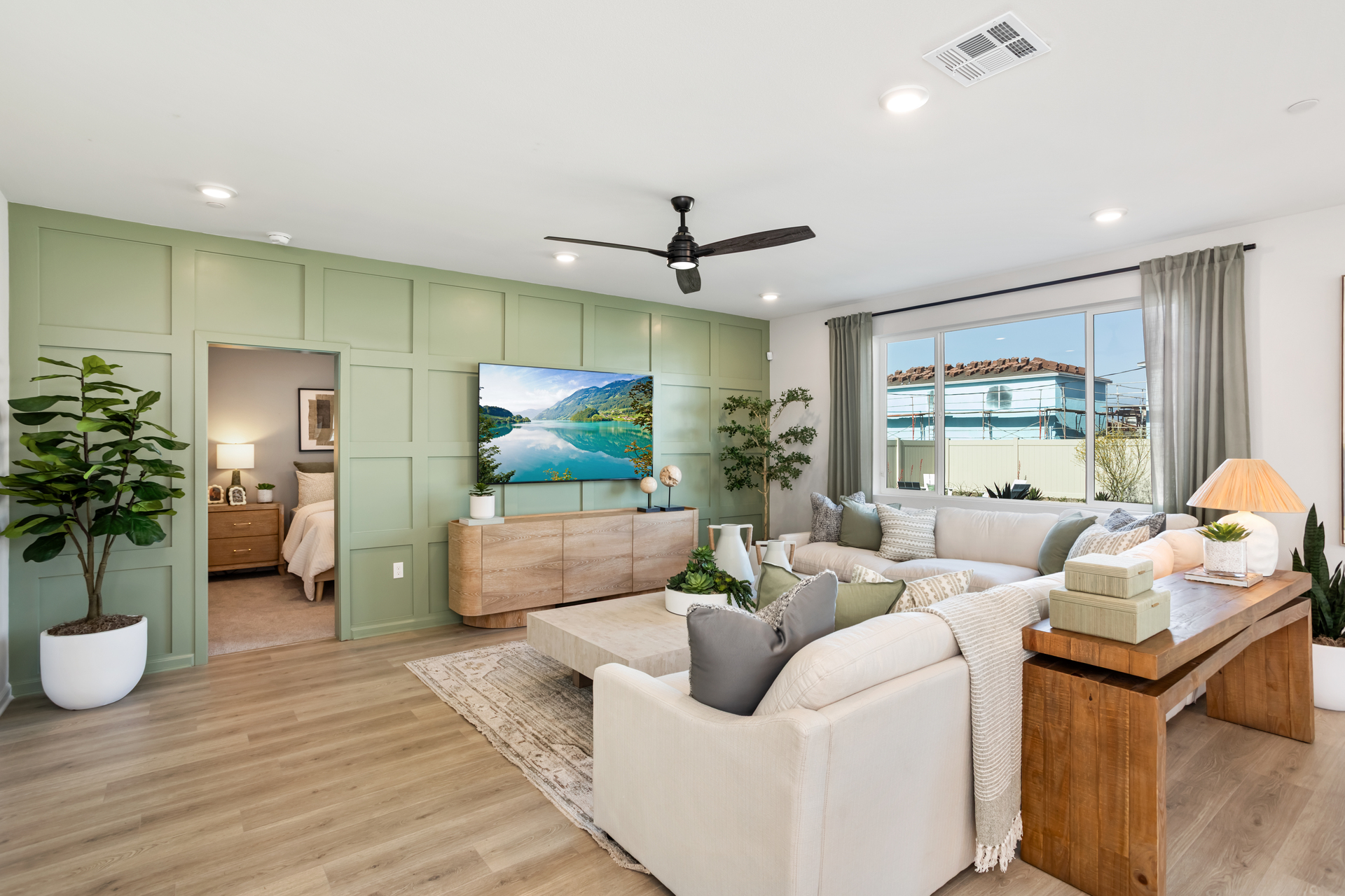 great room with accent wall and large windows