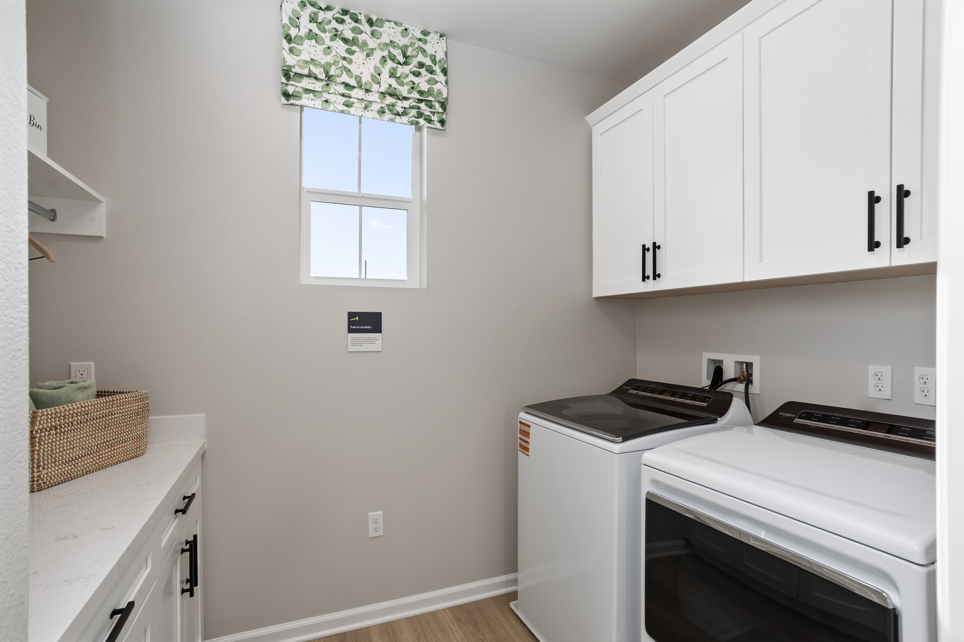 laundry room with window and storage