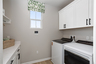 laundry room with window and storage