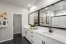 primary bathroom with white countertops and cabinets