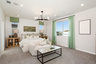primary bedroom with neutral floors and large windows