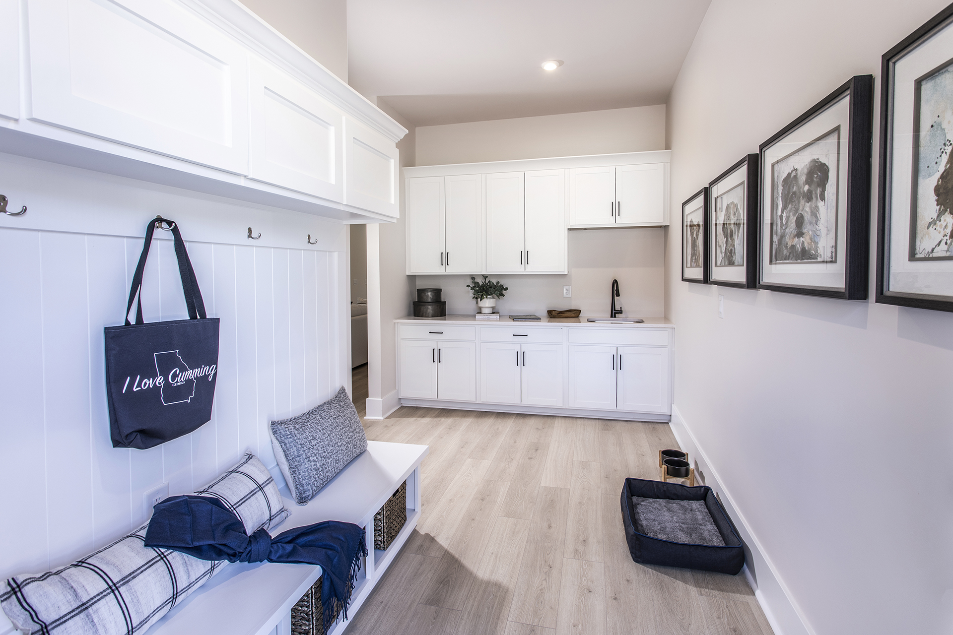 mudroom with white cabinetry and hard-surface flooring