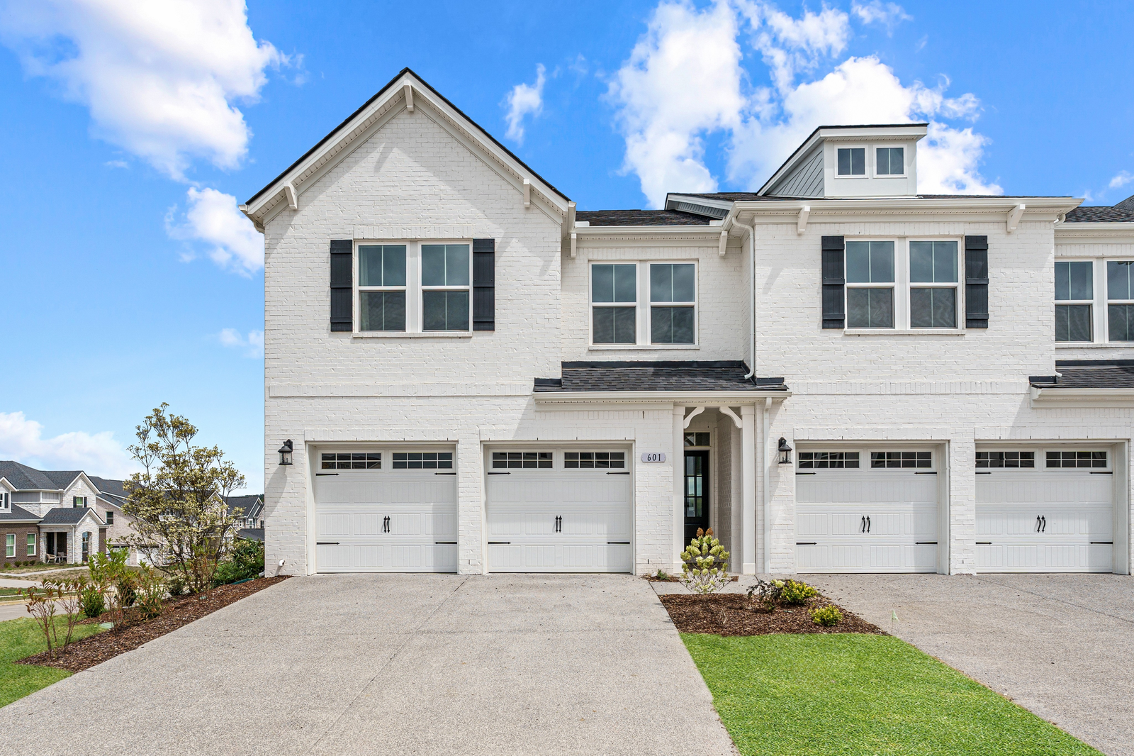 exterior with white brick and two car garage