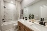 dual sink vanity with water closet and tub