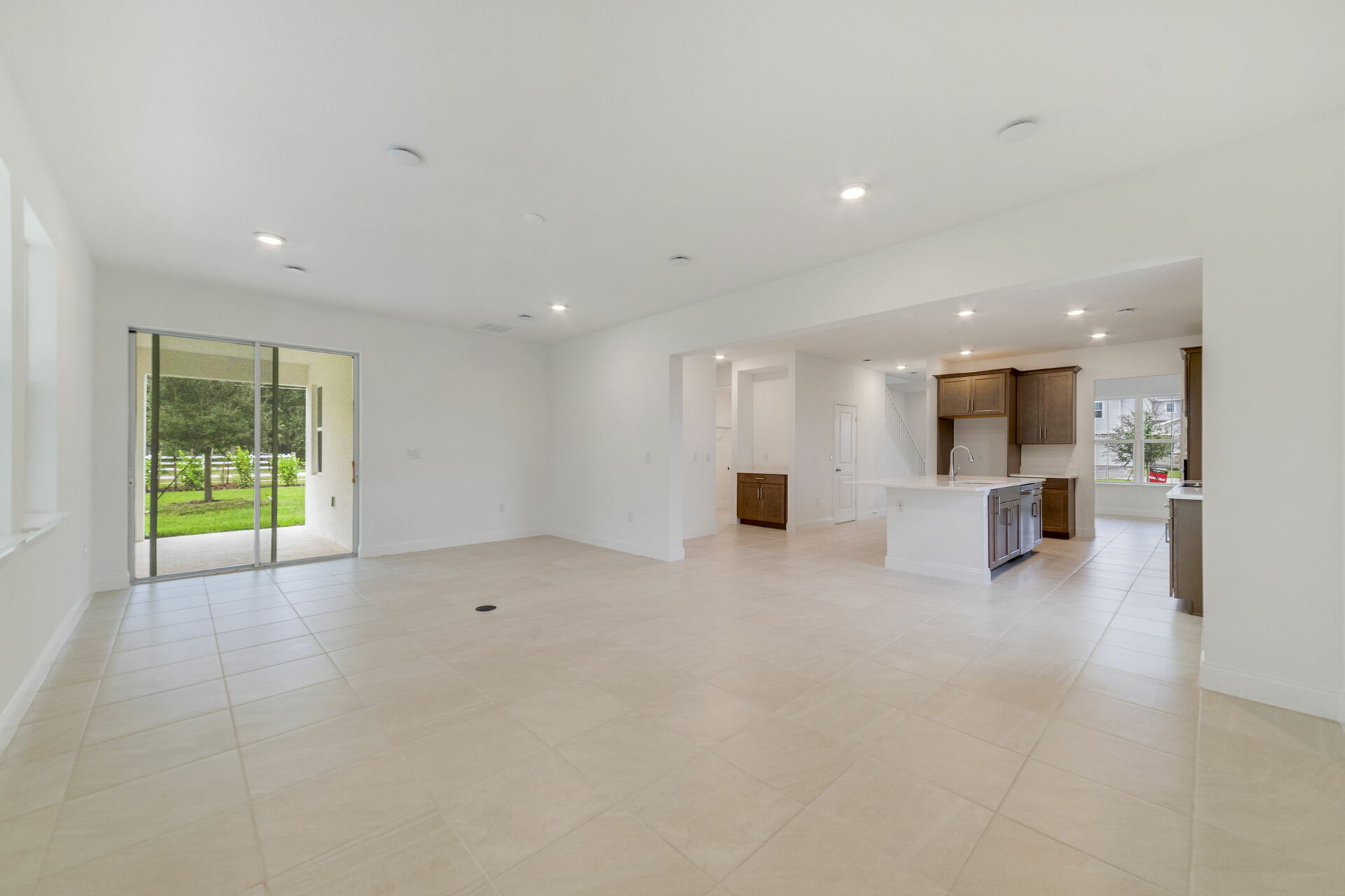 great room with access to covered patio and kitchen