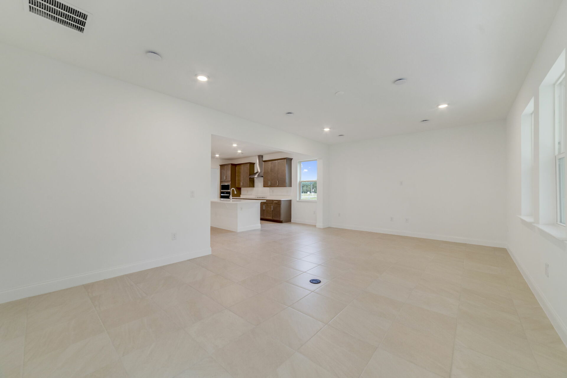 great room with access to covered patio and kitchen