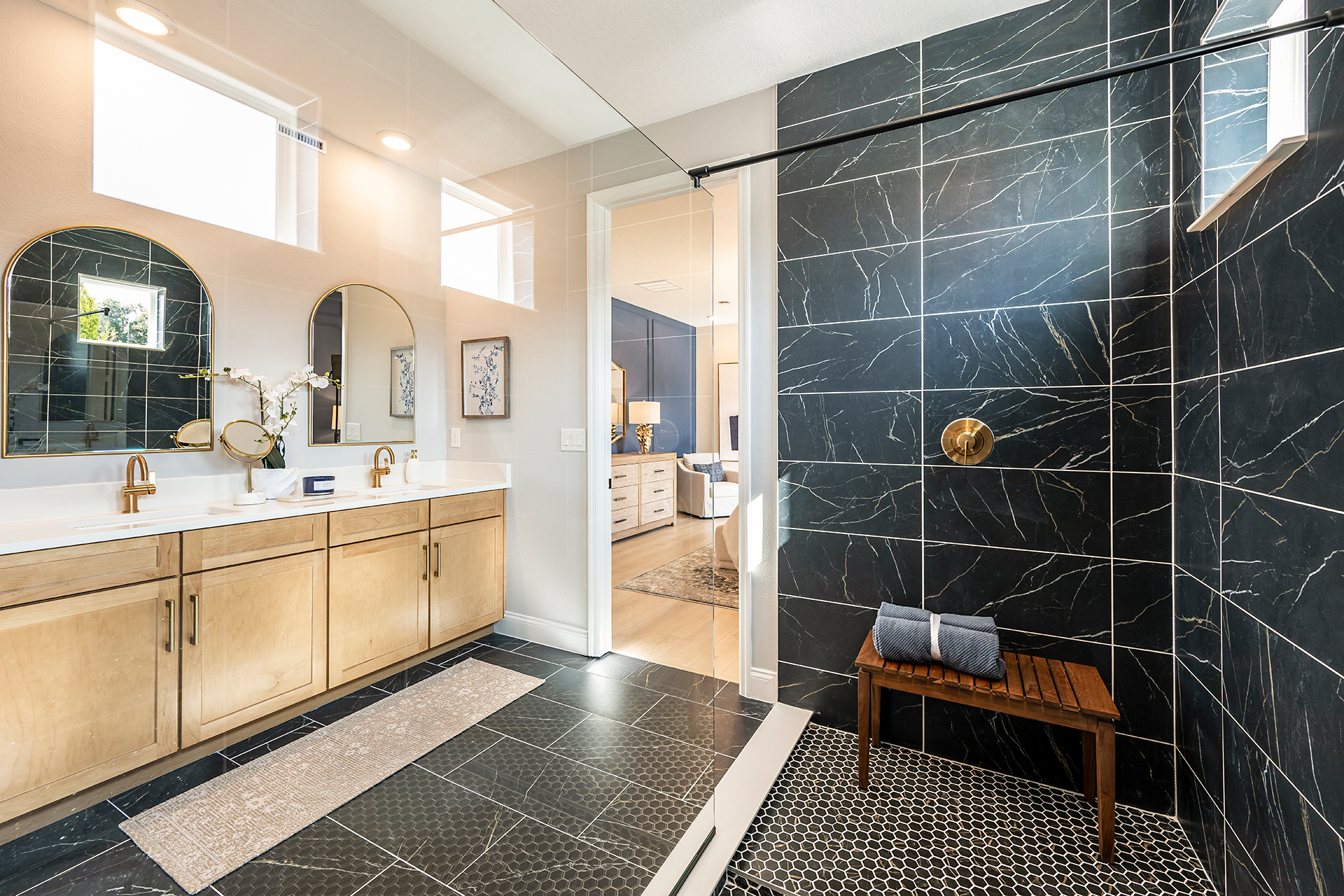 primary bathroom with black tile and enlarged glass shower