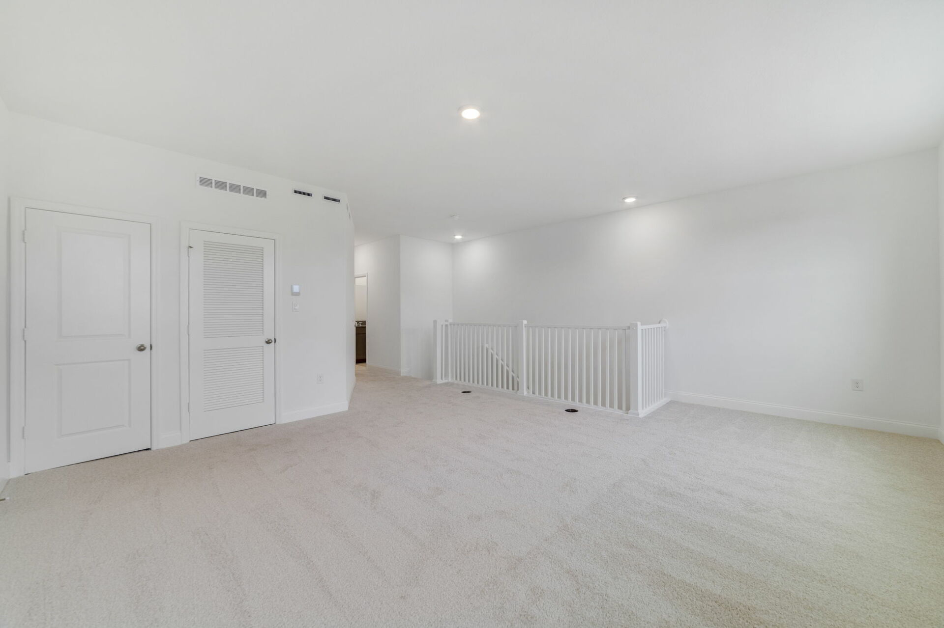 loft with carpet and access to the stairs