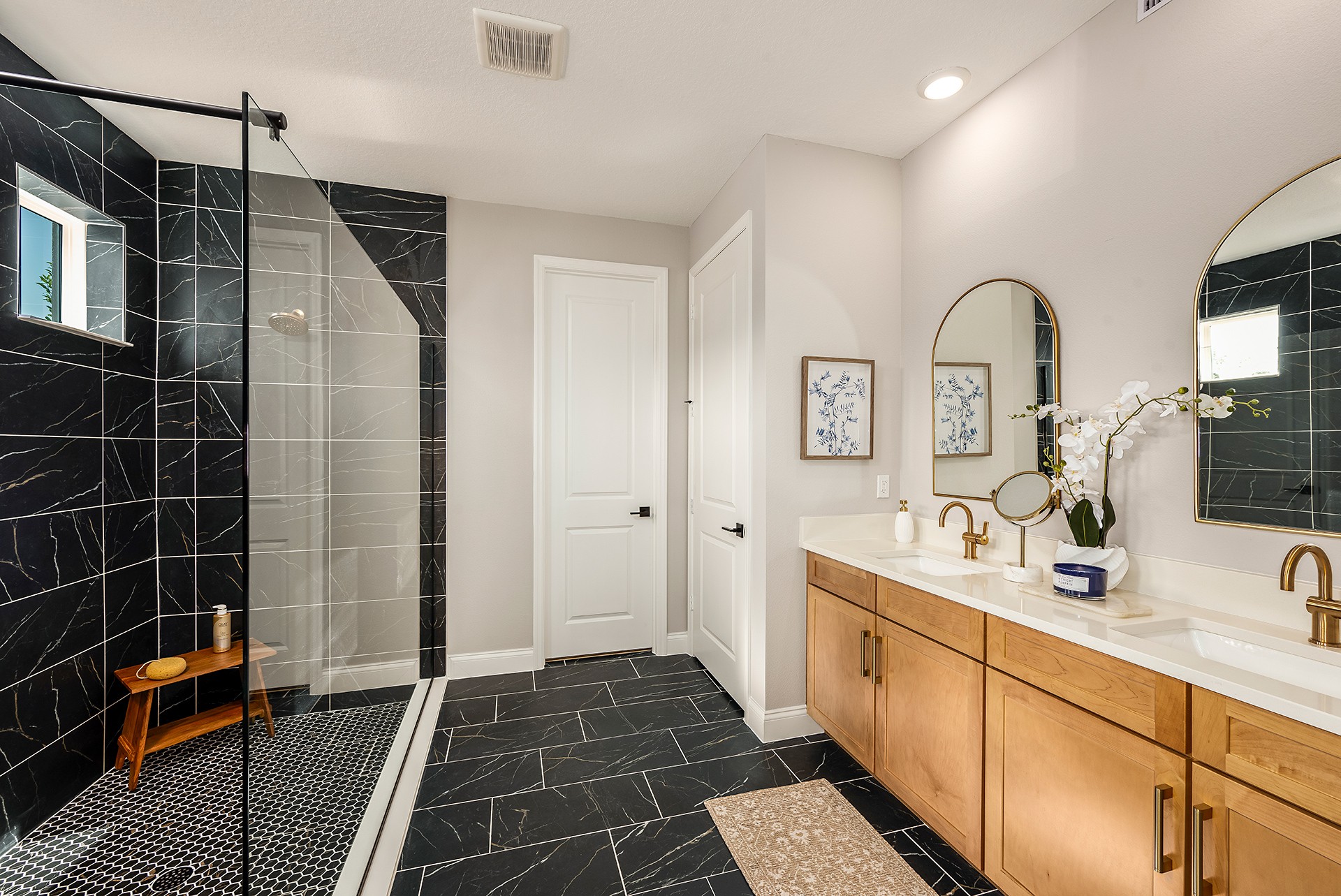 dual sink vanity with oversized shower and large mirrors