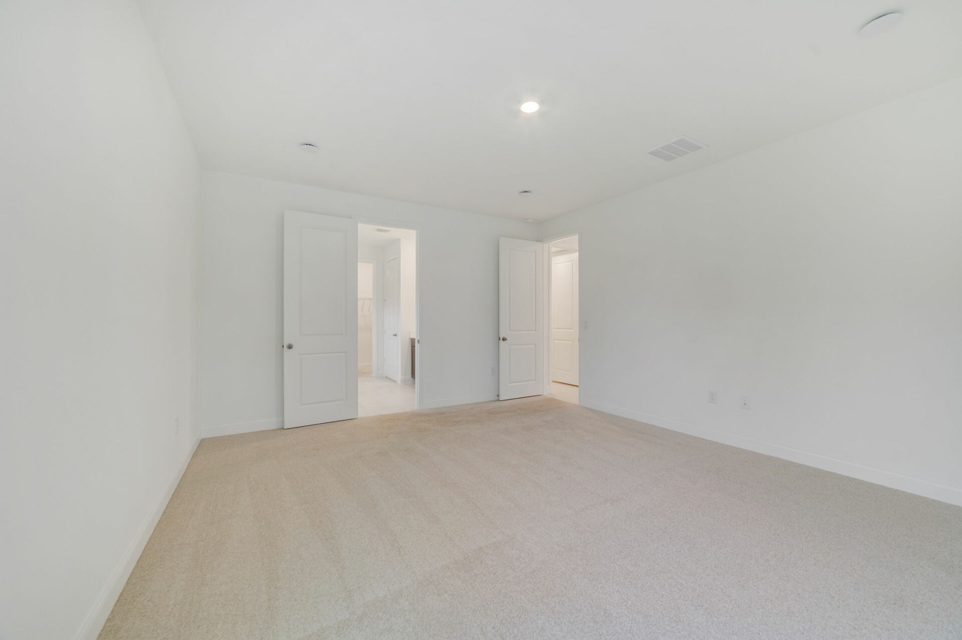 primary bedroom with carpet and access to the bathroom